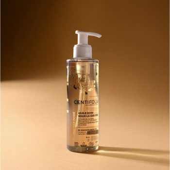 Frasco transparente com doseador contendo óleo de duche Centifolia Nectar Dourado, enriquecido com óleo de camélia, indicado para hidratação e suavidade da pele, embalagem de 195 ml.